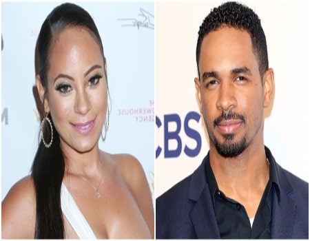 Aja is wearing white dress whereas Doman is wearing dark blue coat with black shirt.